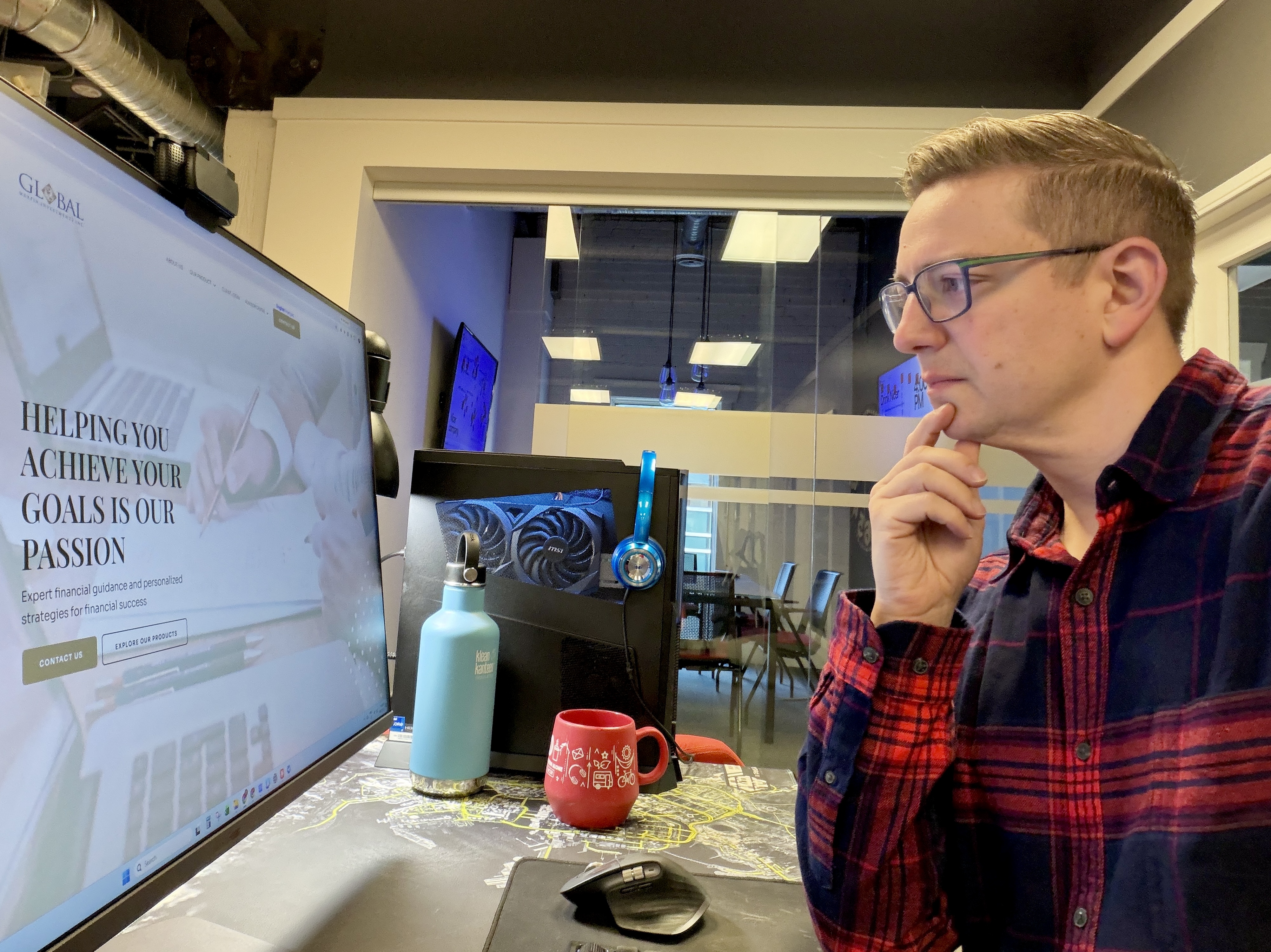 Scott at his desk, looking thoughtfully at his computer screen