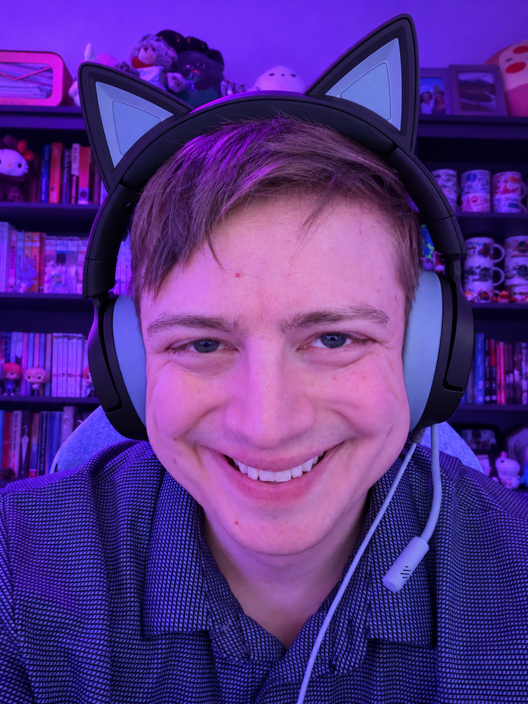 Scott smiling in a cat-ear gaming headset and collared shirt